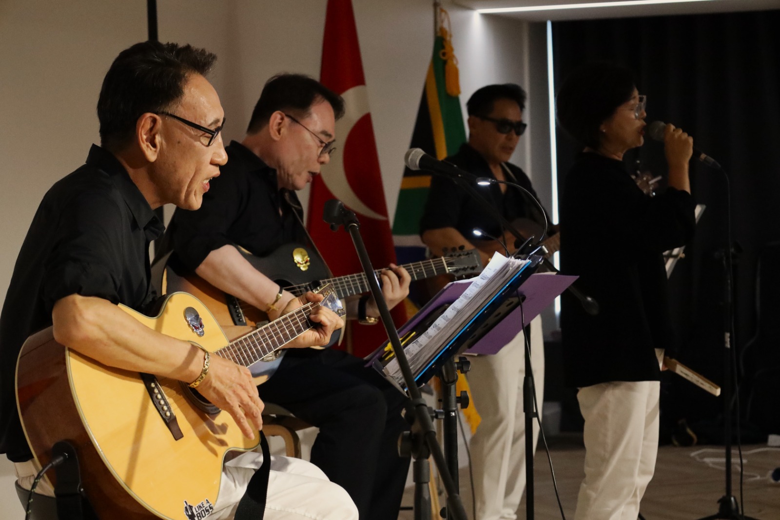 A group of people playing instruments

Description automatically generated