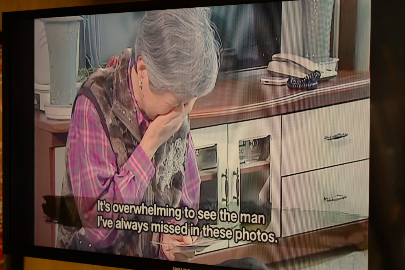 A person crying in front of a television

Description automatically generated