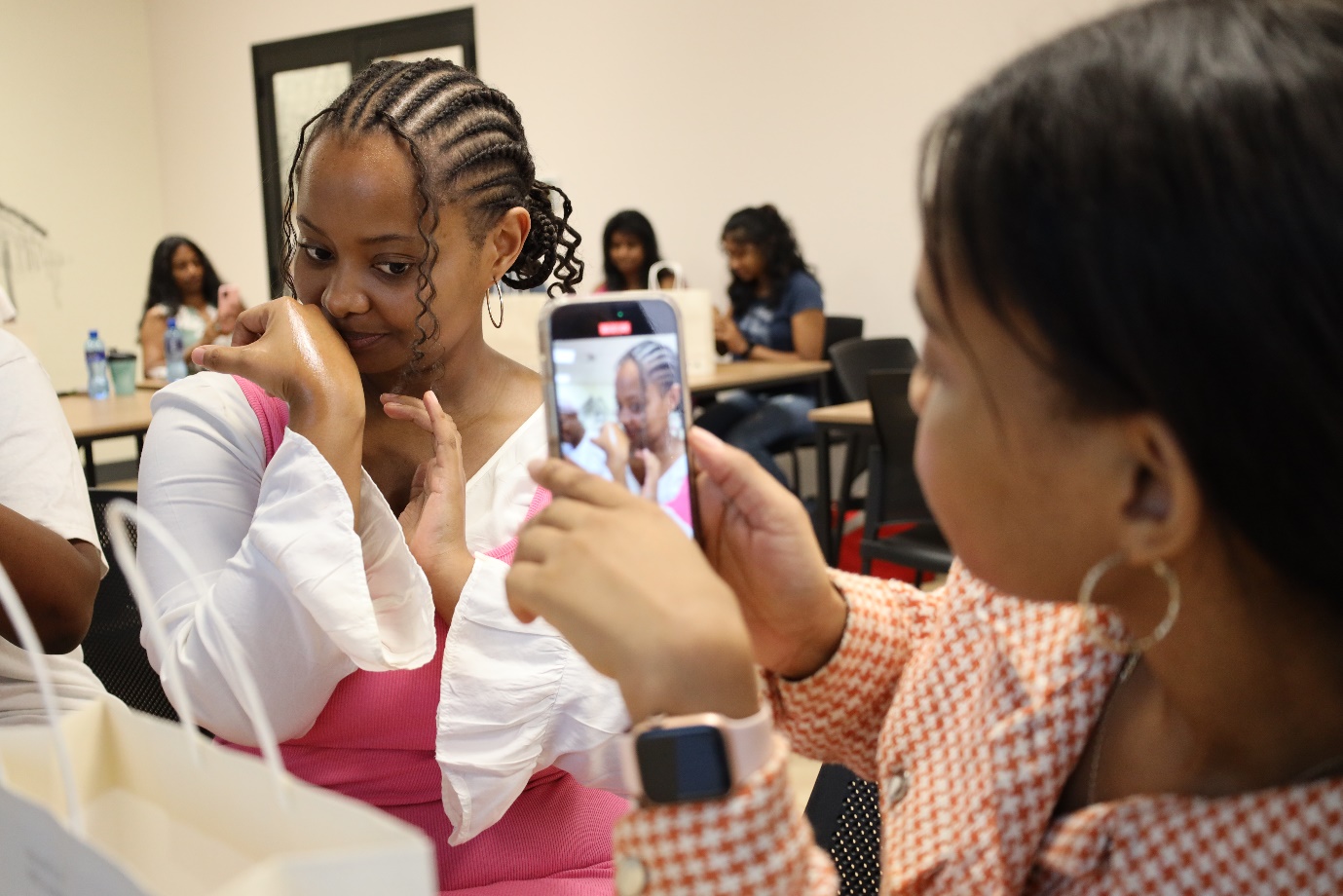 A person taking a picture of a baby
Description automatically generated