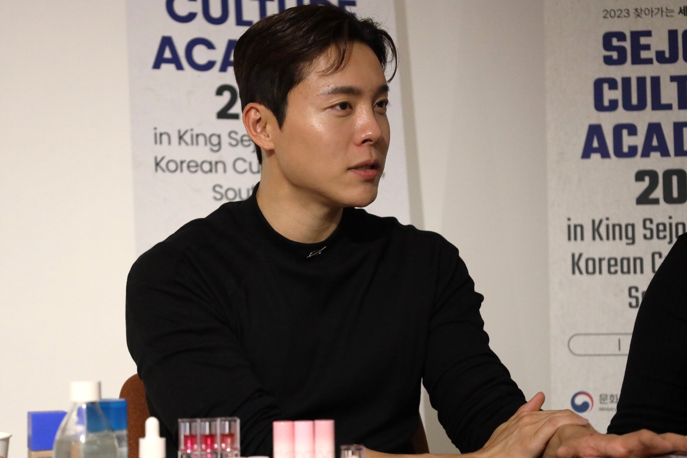 A person sitting at a table

Description automatically generated