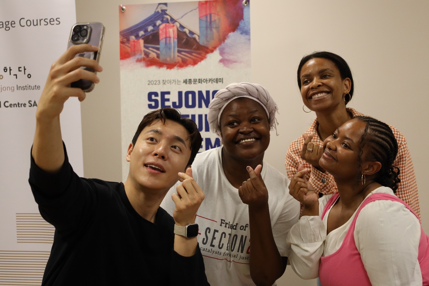 A group of people taking a selfie

Description automatically generated