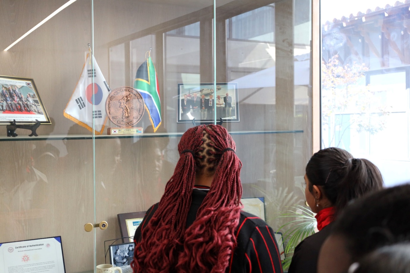 A group of people looking at flags

Description automatically generated