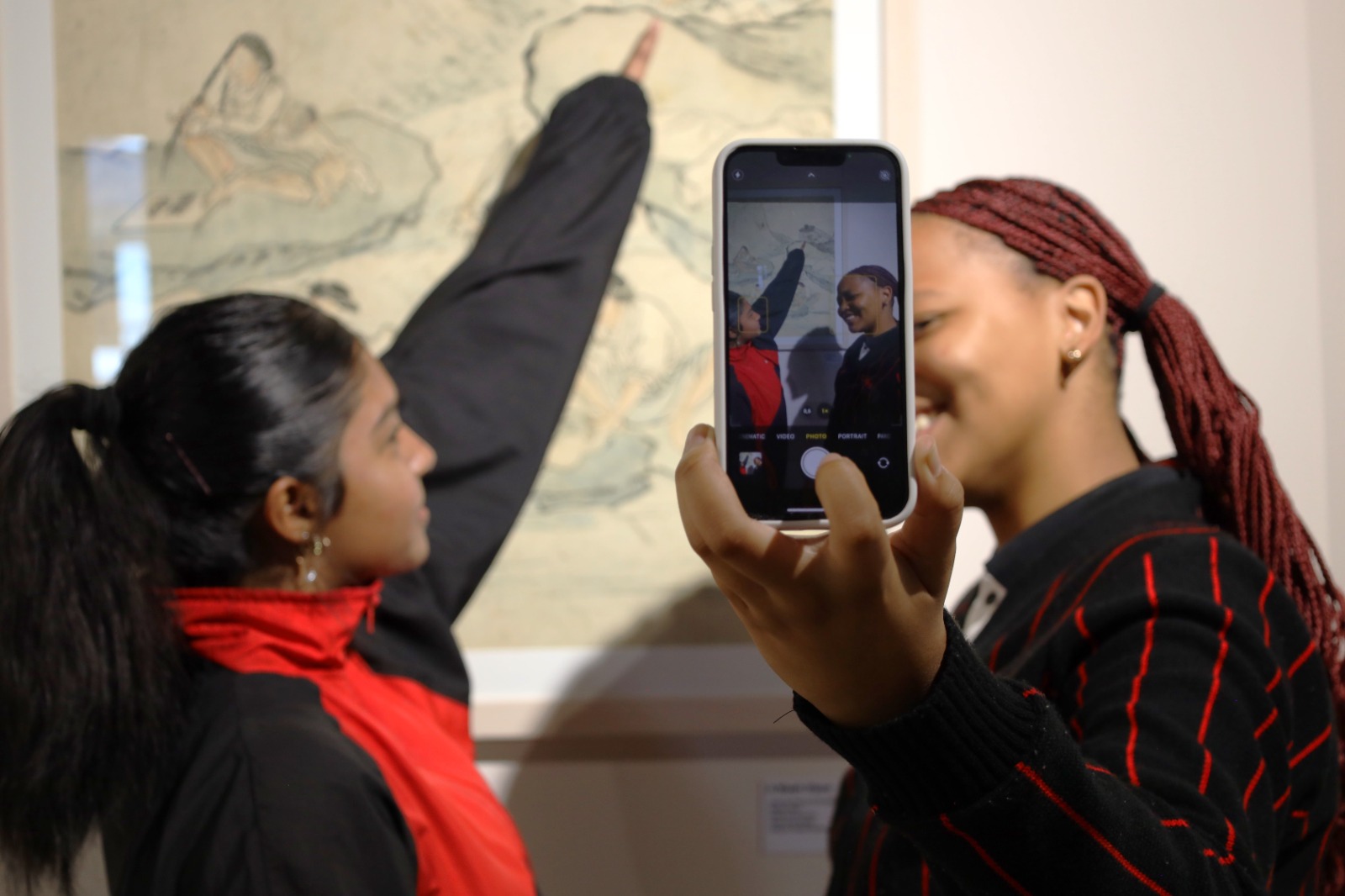 A person taking a picture of another person

Description automatically generated