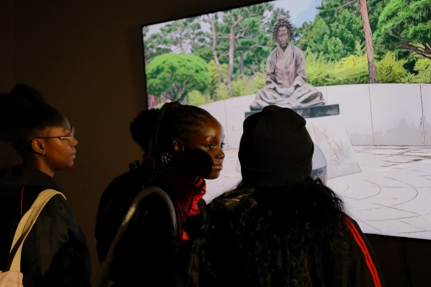 A group of people looking at a screen

Description automatically generated