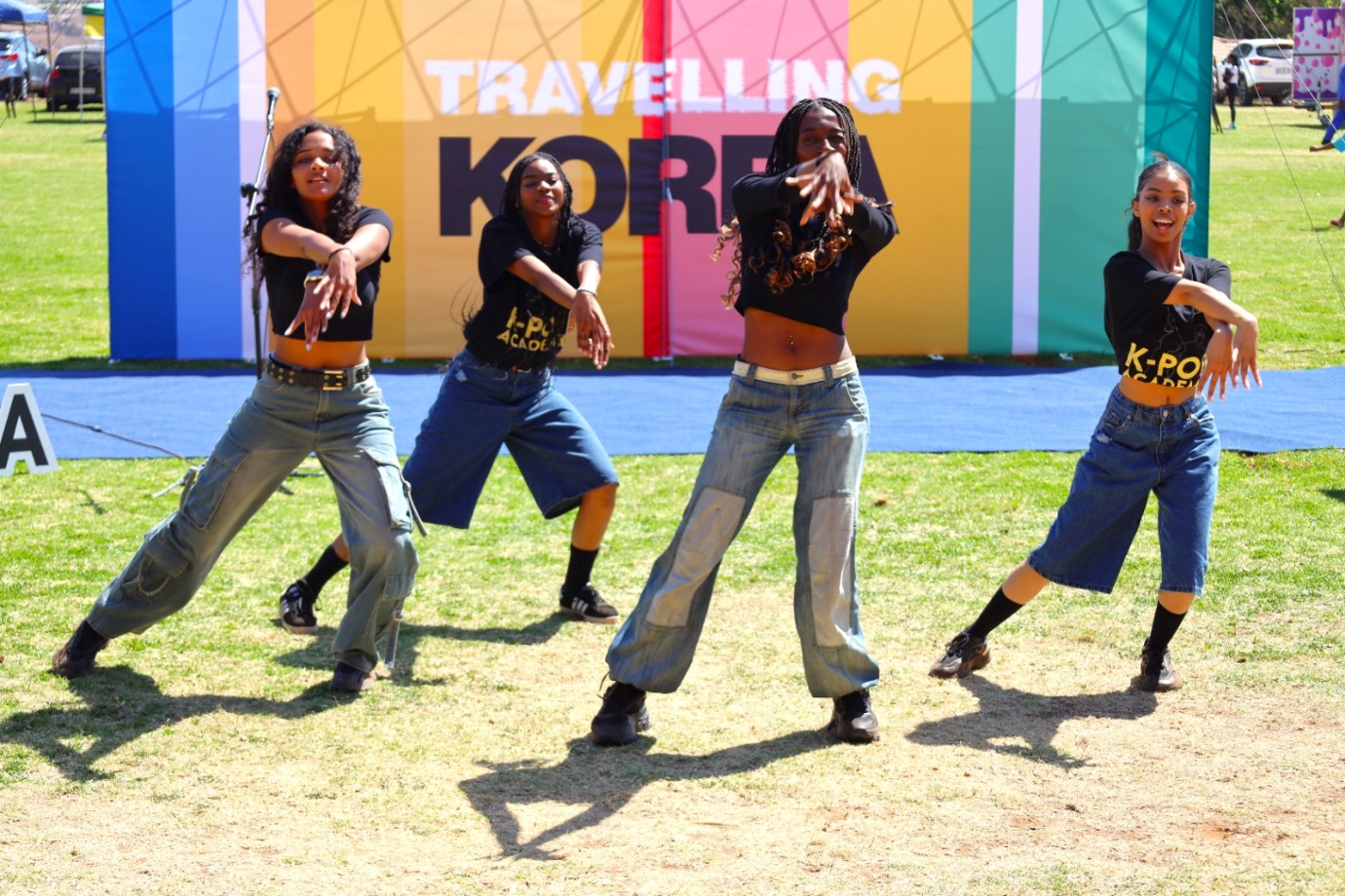 A group of women dancing on a field

Description automatically generated