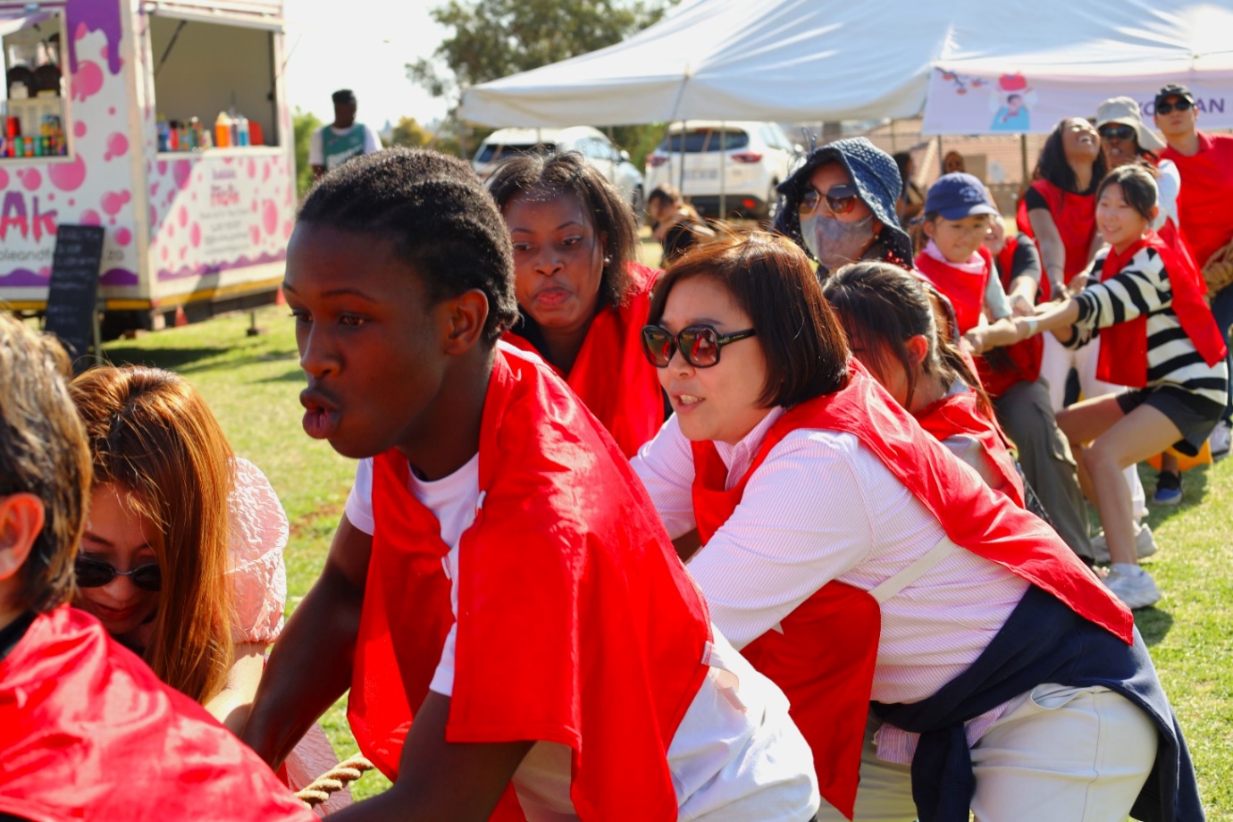 A group of people wearing red capes

Description automatically generated