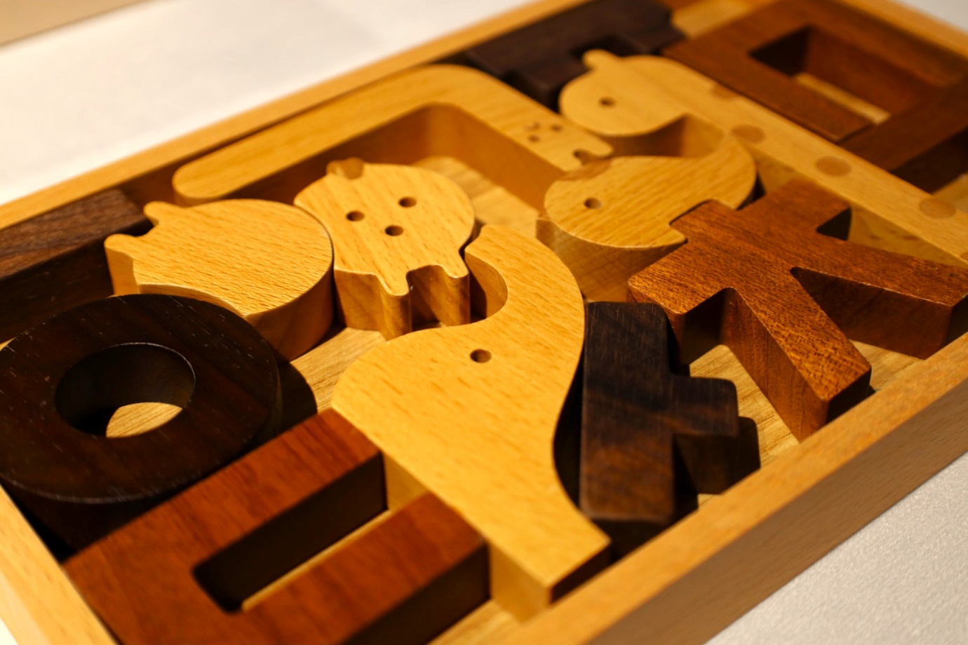 A wooden puzzle with different shapes

Description automatically generated