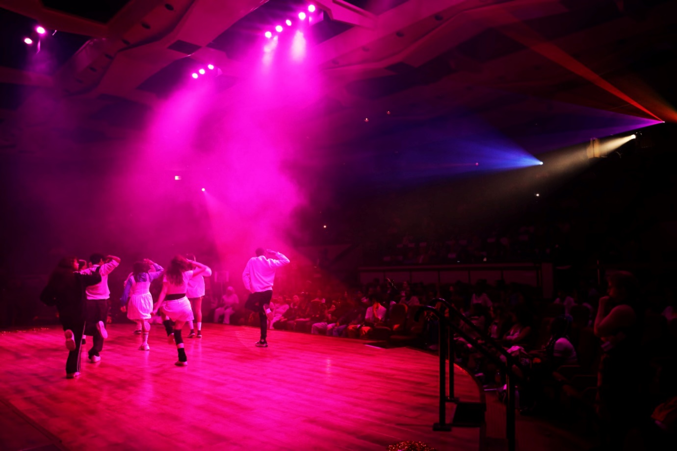 A group of people dancing on a stage

Description automatically generated