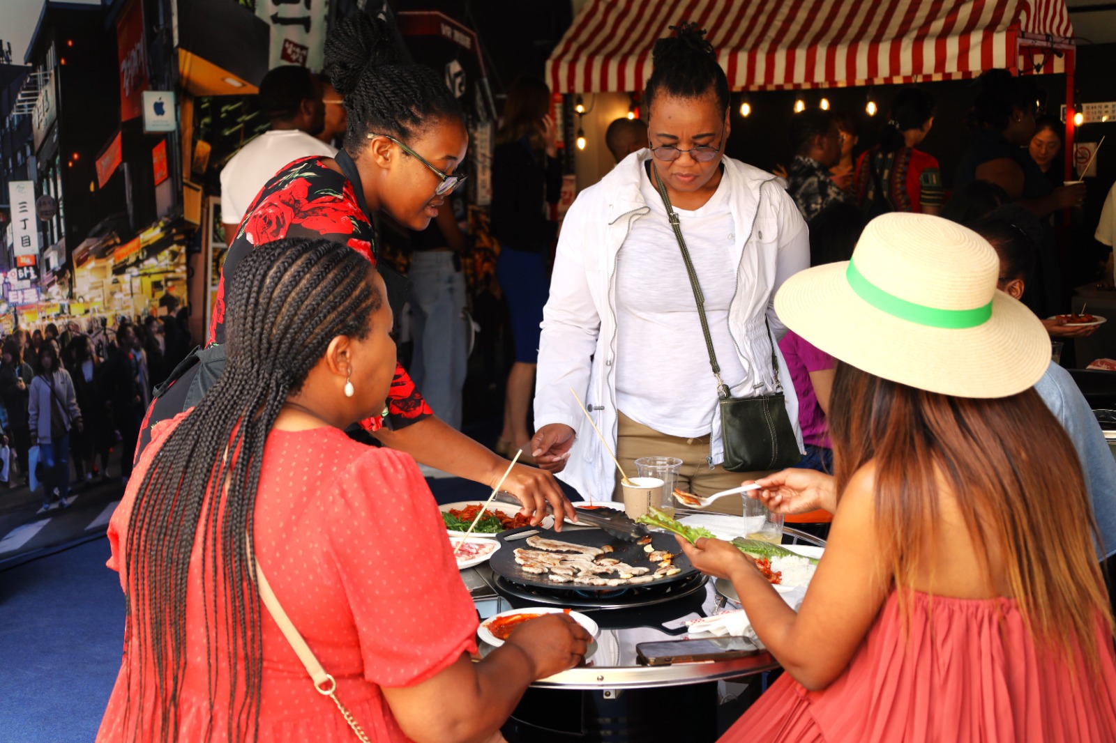 A group of women eating food

Description automatically generated