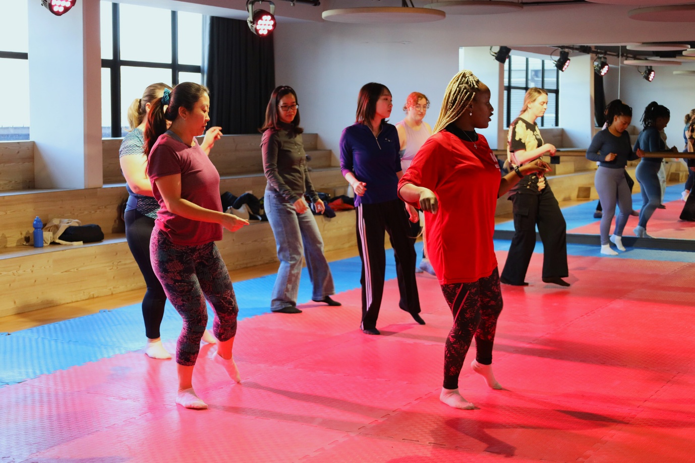 A group of people dancing in a room
AI-generated content may be incorrect.