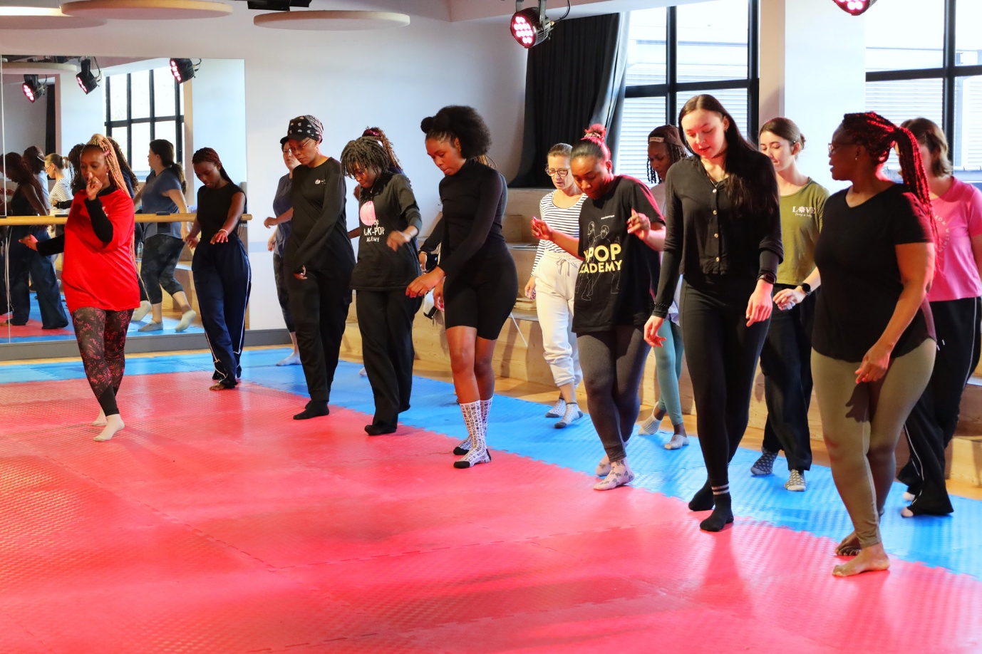 A group of women dancing in a room
AI-generated content may be incorrect.