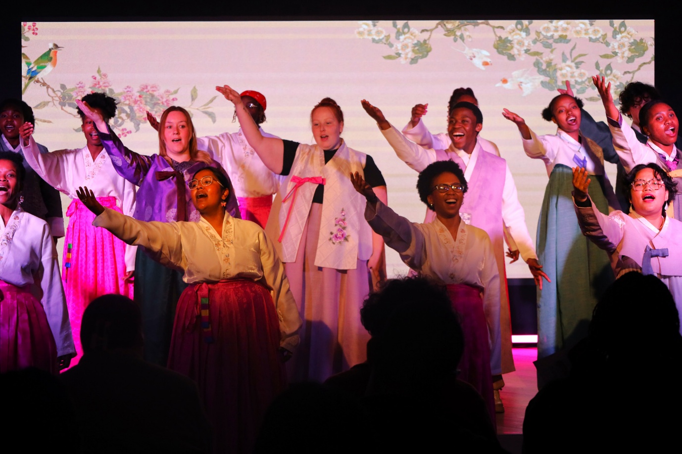 A group of women performing on stage
AI-generated content may be incorrect.