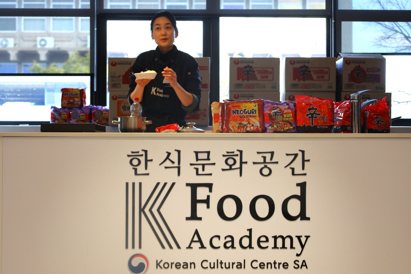 A person standing behind a counter
AI-generated content may be incorrect.