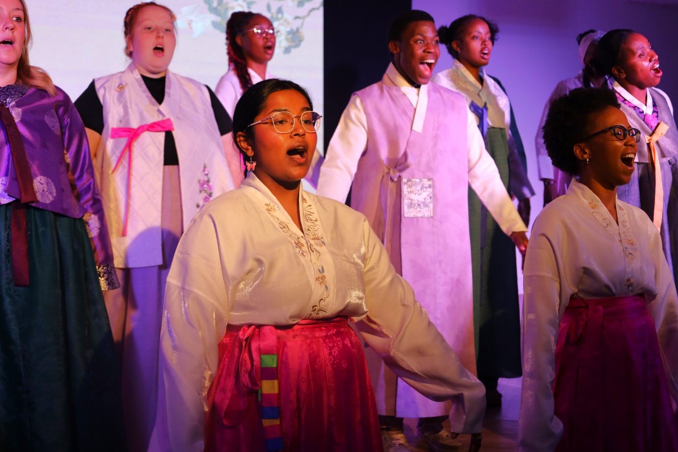 A group of people singing
AI-generated content may be incorrect.