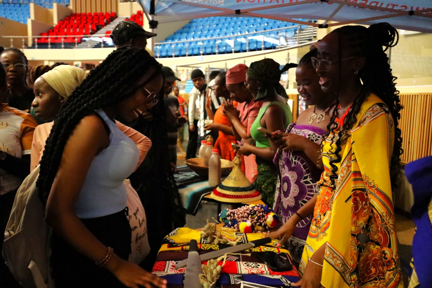 A group of women standing around a table
AI-generated content may be incorrect.