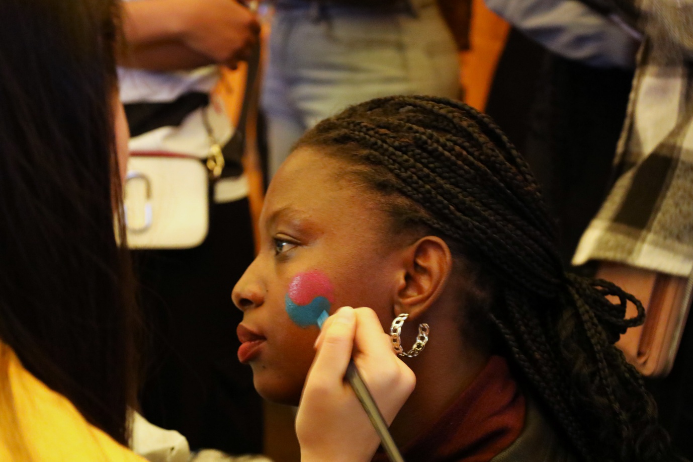 A person getting her face painted
AI-generated content may be incorrect.