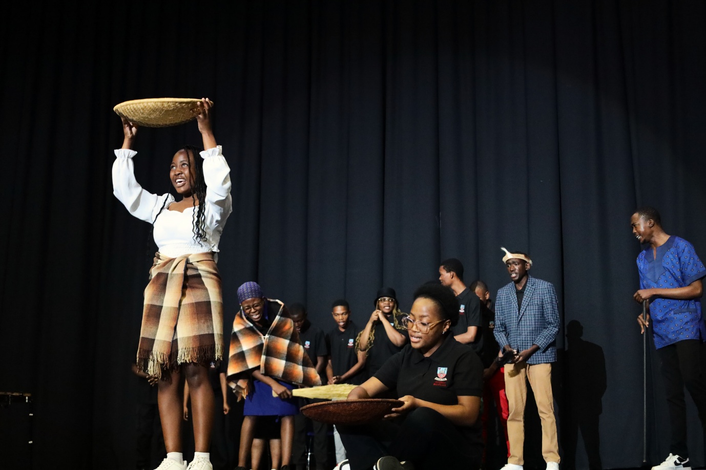 A person standing on a stage holding a hat
AI-generated content may be incorrect.