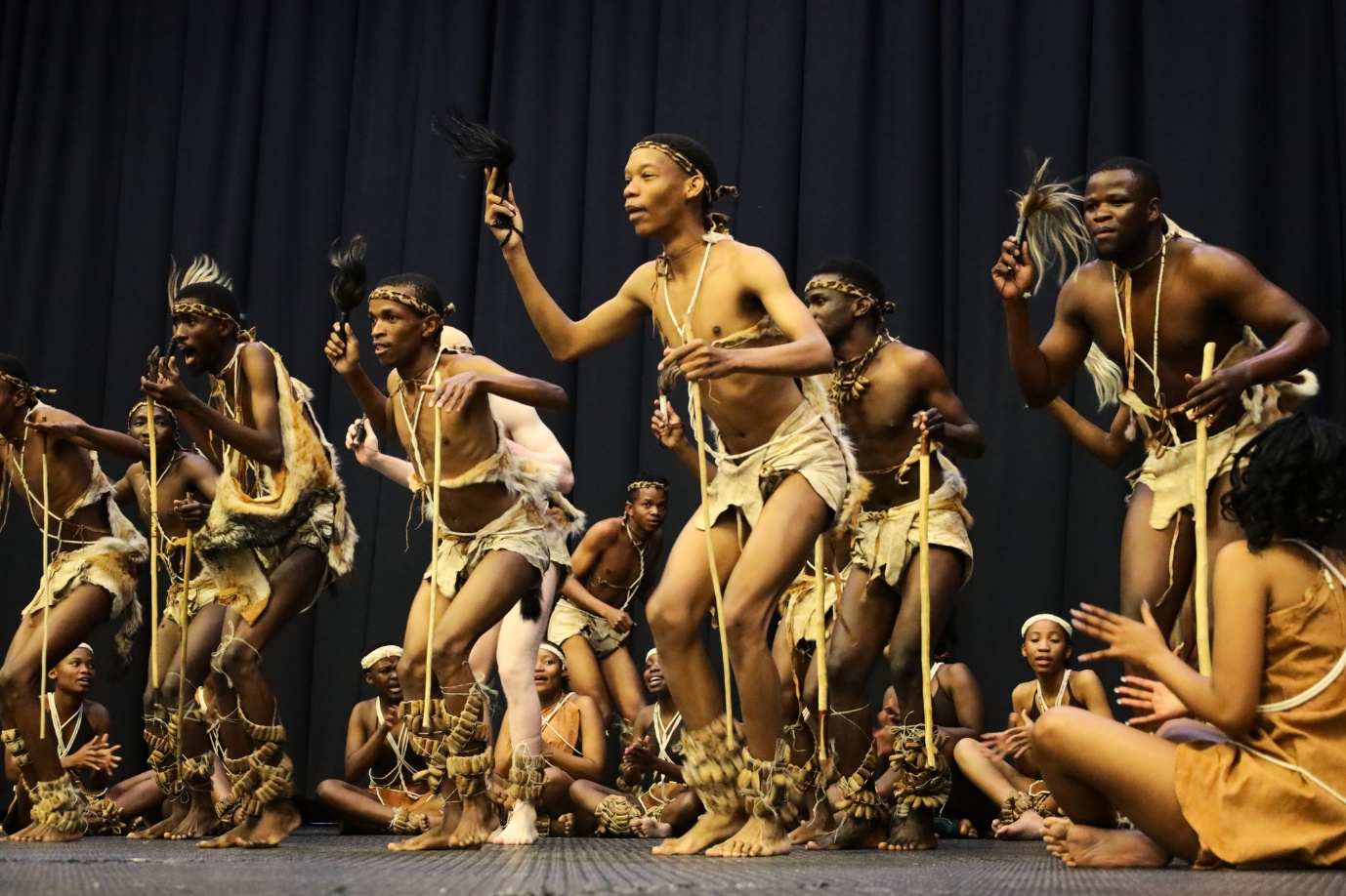 A group of people dancing on a stage
AI-generated content may be incorrect.