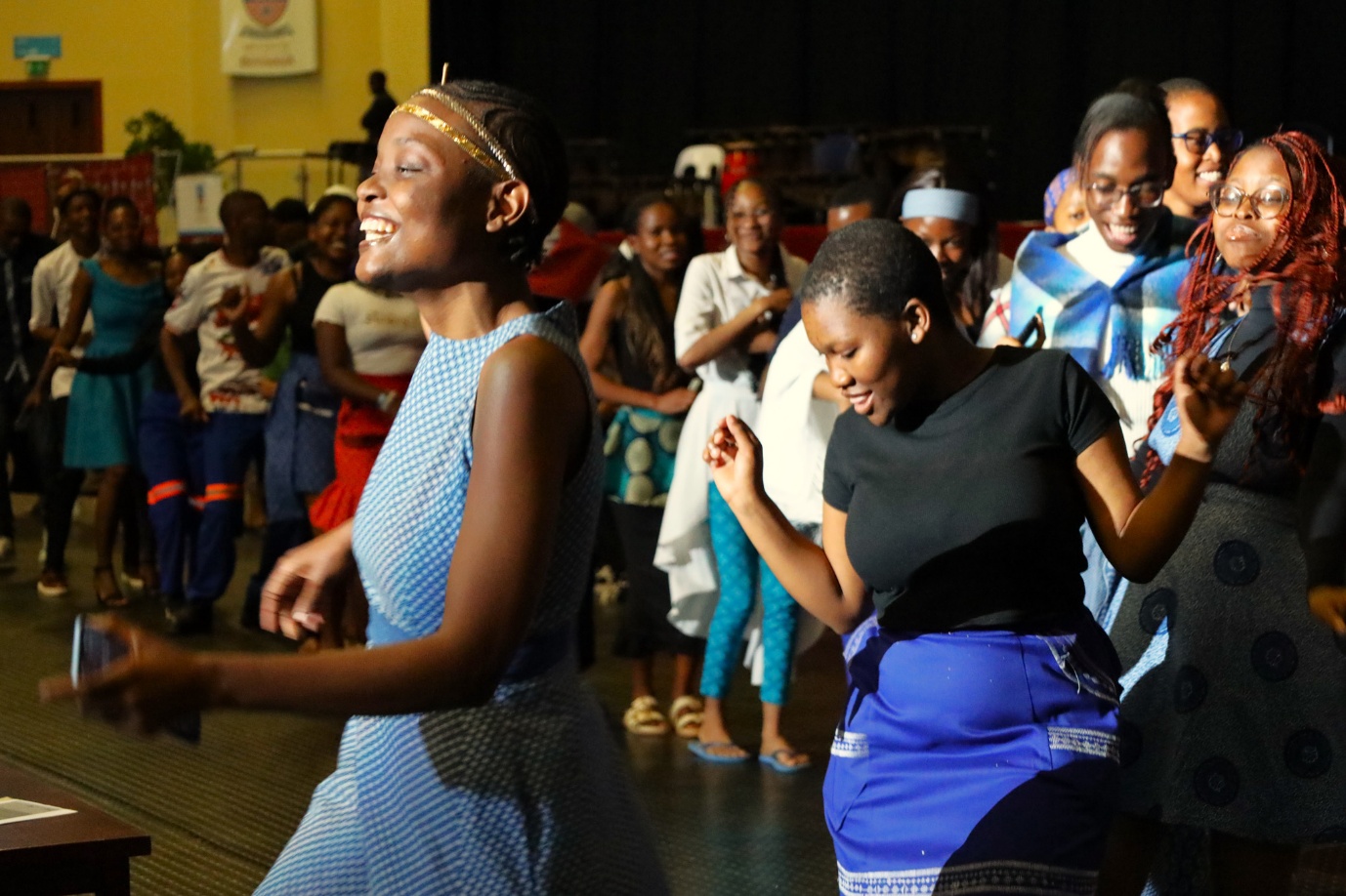 A group of women dancing in a room
AI-generated content may be incorrect.