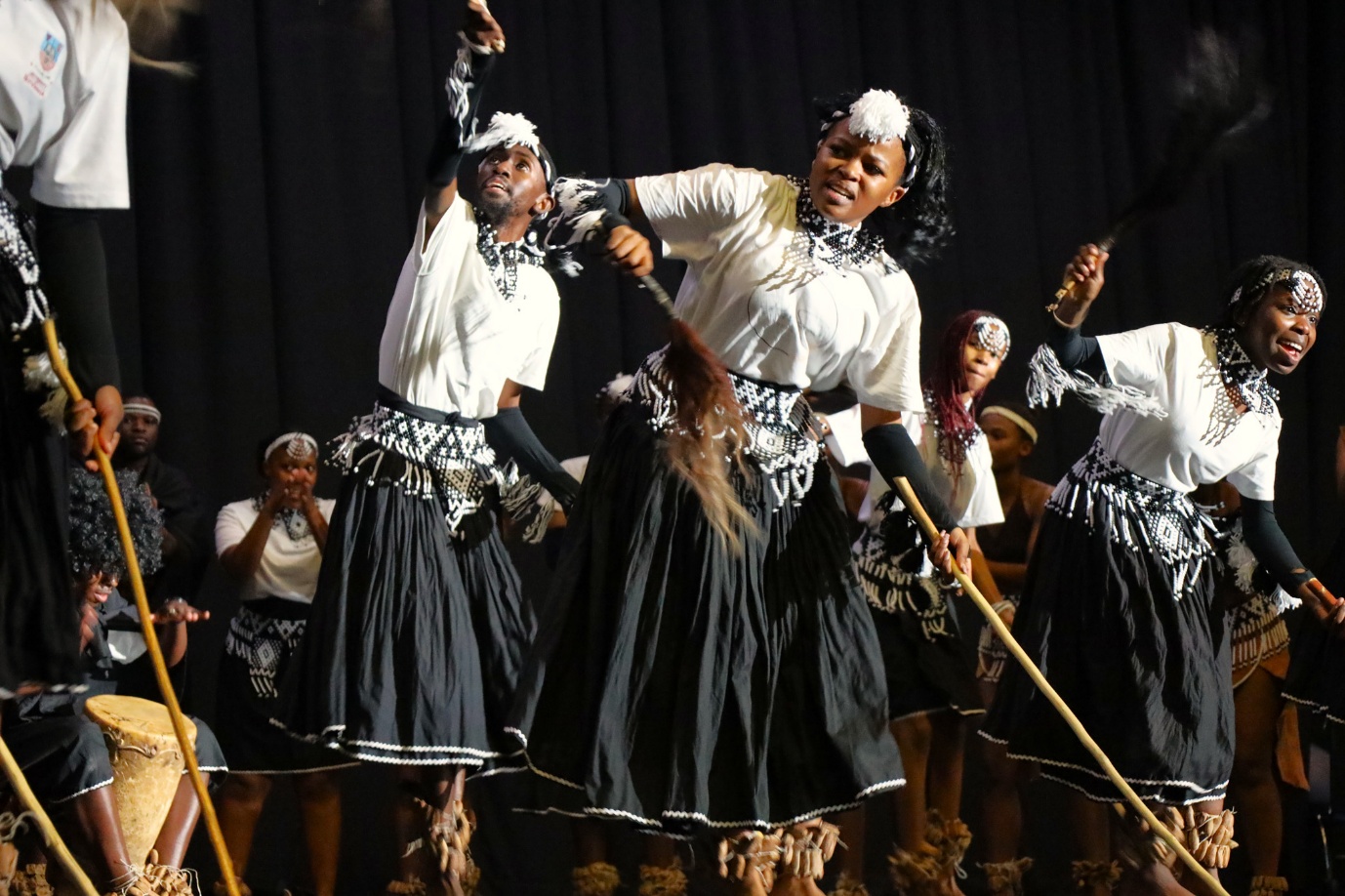 A group of women dancing on stage
AI-generated content may be incorrect.