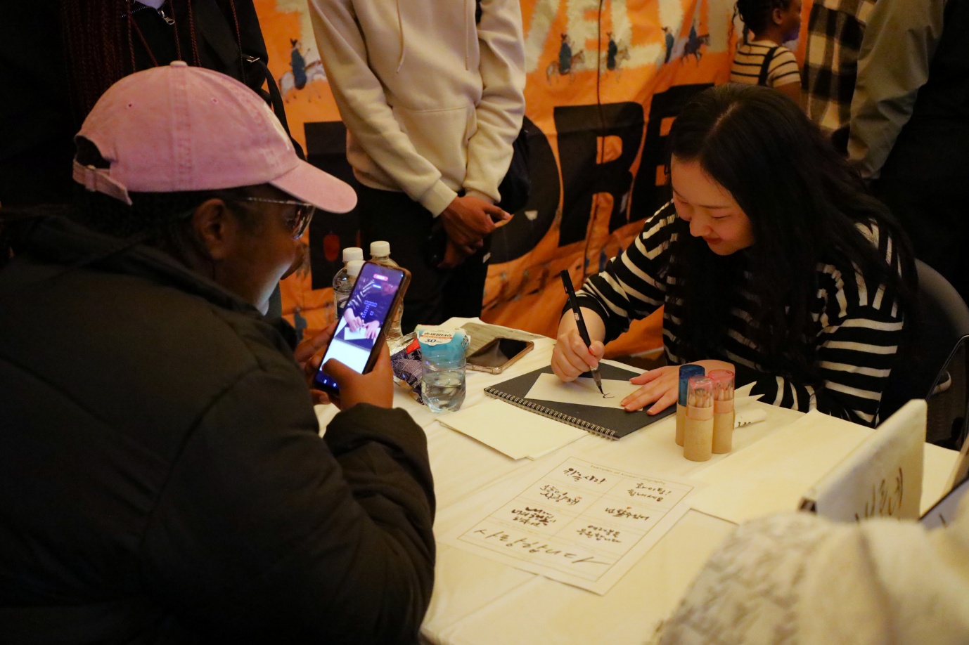 A person and person signing a book
AI-generated content may be incorrect.