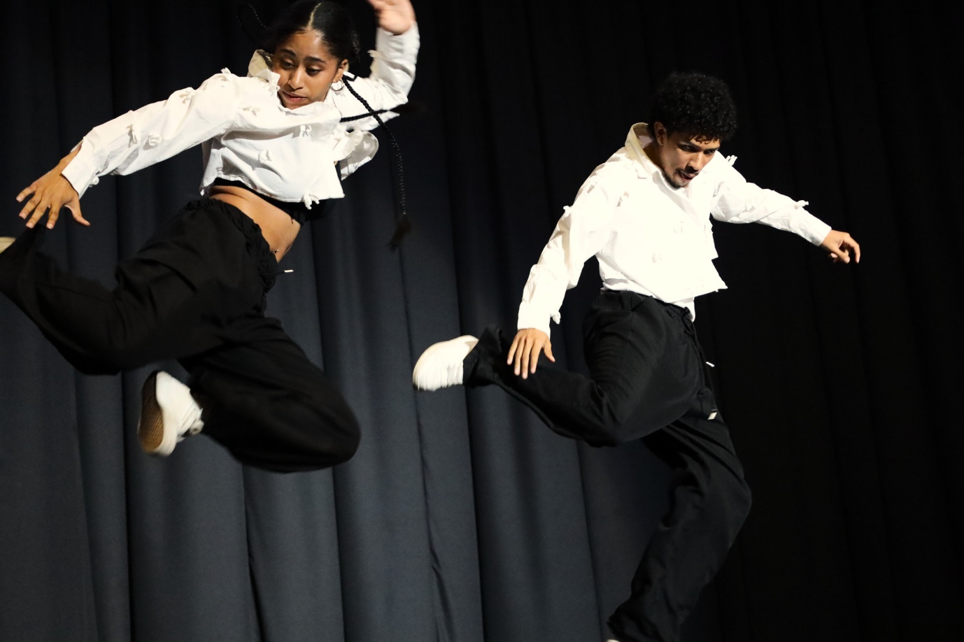 A person and person dancing on stage
AI-generated content may be incorrect.