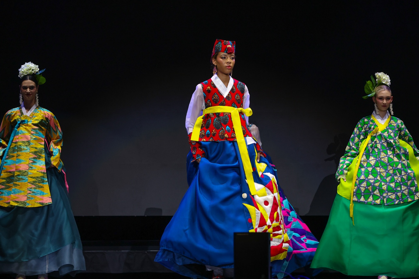 A group of women wearing colorful dresses

AI-generated content may be incorrect.