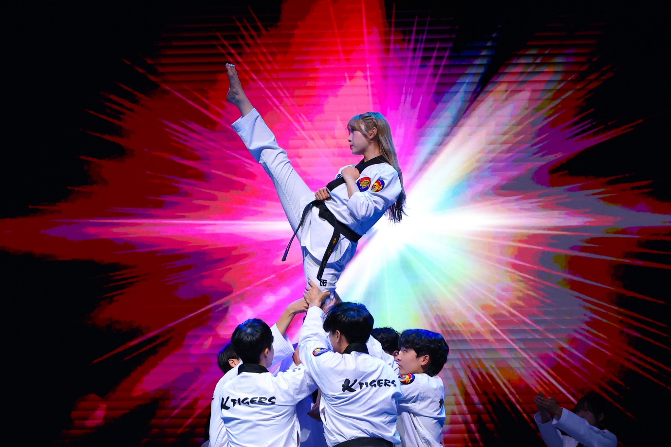 A person lifting a leg in front of a group of people

AI-generated content may be incorrect.