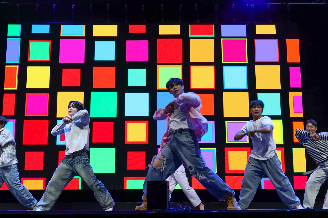 A group of men dancing on a stage

AI-generated content may be incorrect.