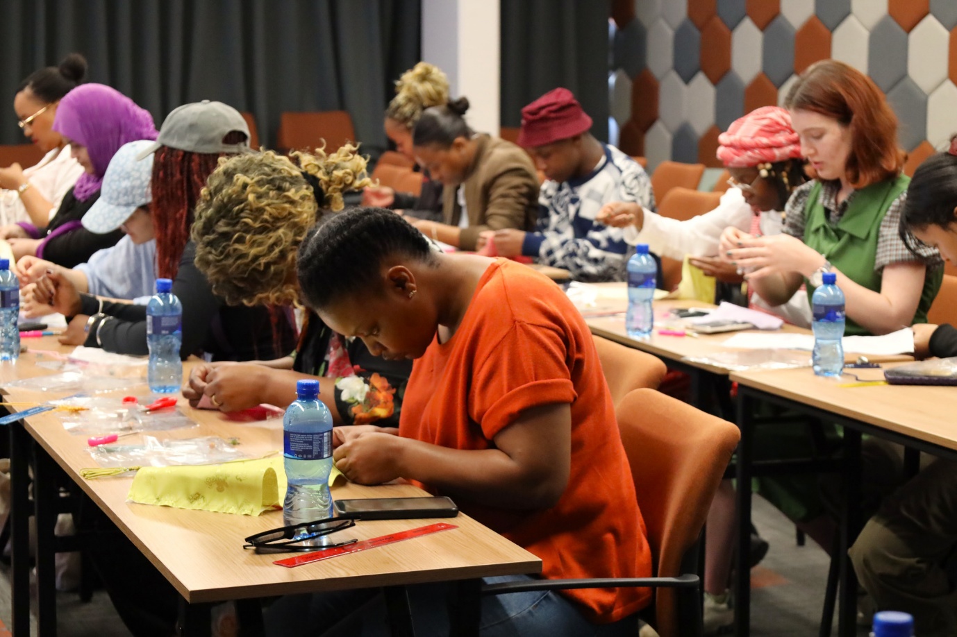 A group of people sitting at tables
AI-generated content may be incorrect.