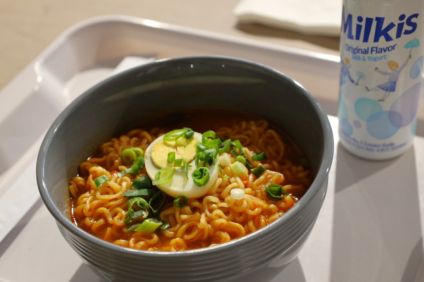 A bowl of ramen with egg and green onions

AI-generated content may be incorrect.