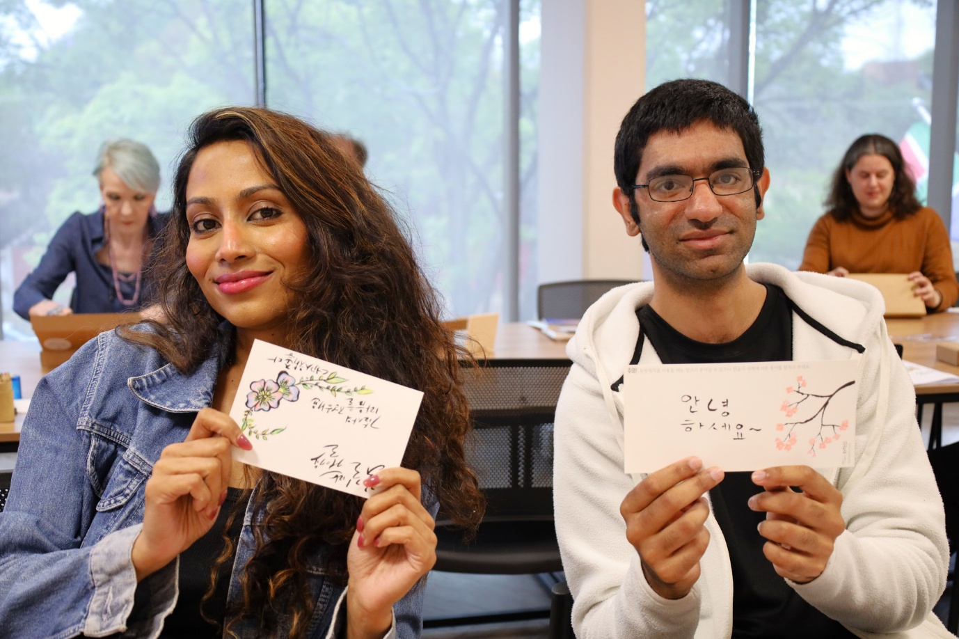 A group of people holding up signs

AI-generated content may be incorrect.