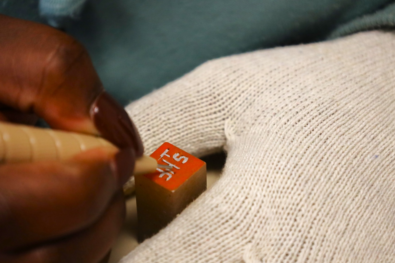 A person writing on a rubber stamp

AI-generated content may be incorrect.