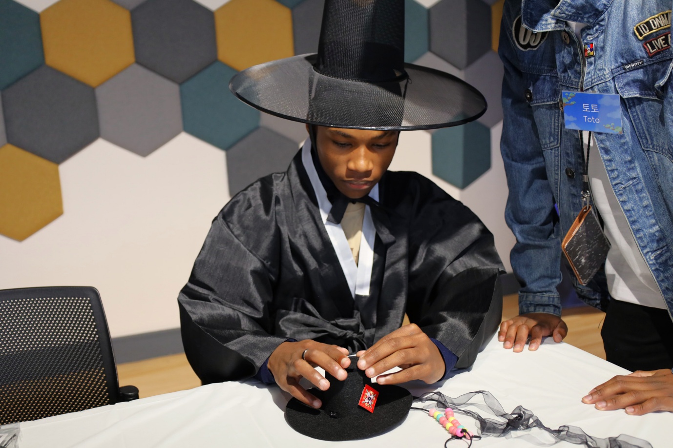 A person in a black robe and hat

AI-generated content may be incorrect.