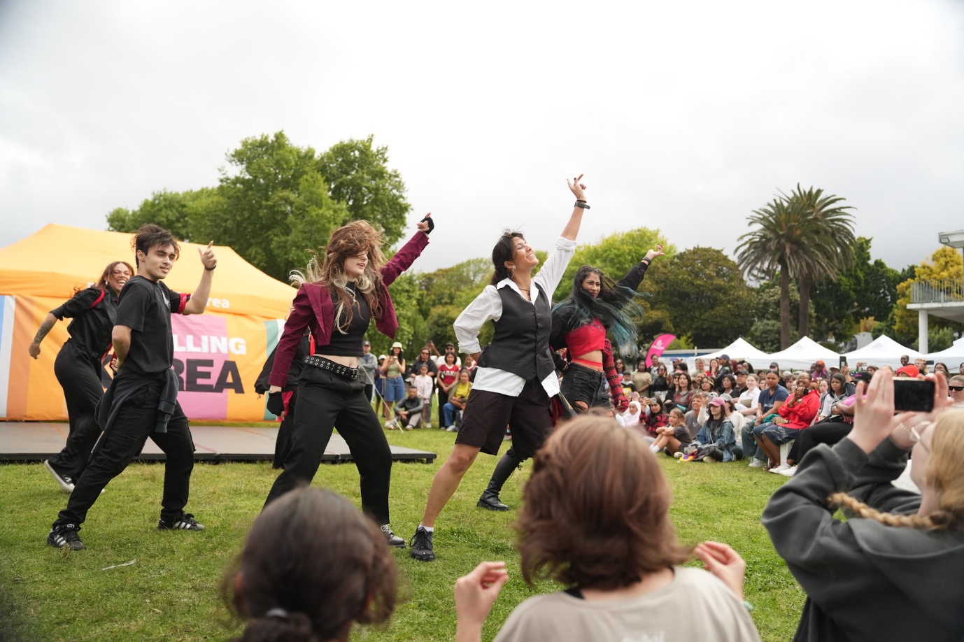 A group of people dancing in a park

AI-generated content may be incorrect.