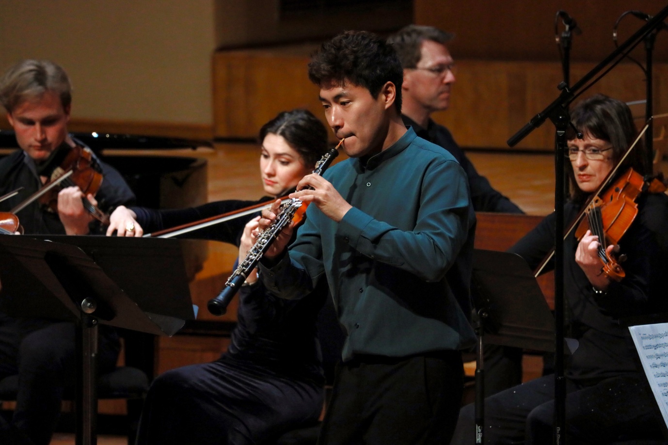 A group of people playing instruments

AI-generated content may be incorrect.