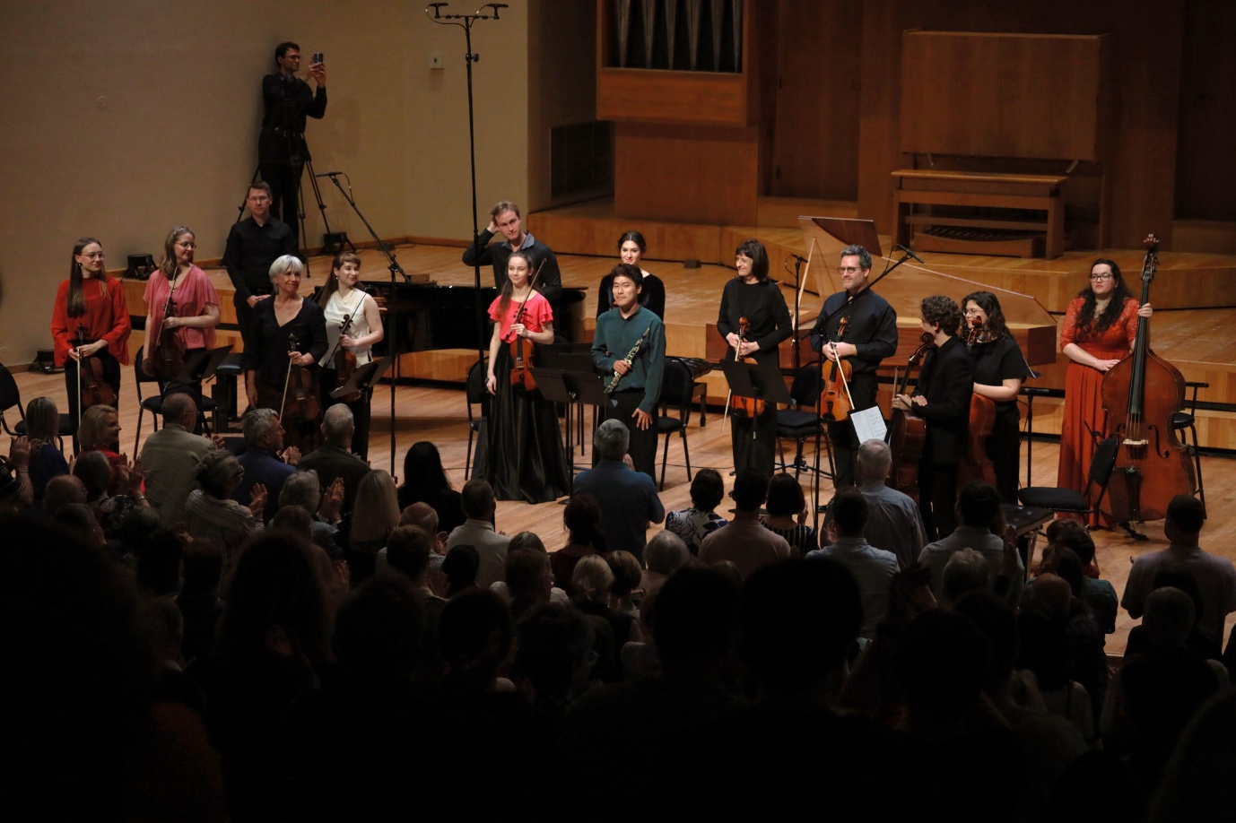 A group of people performing on stage

AI-generated content may be incorrect.