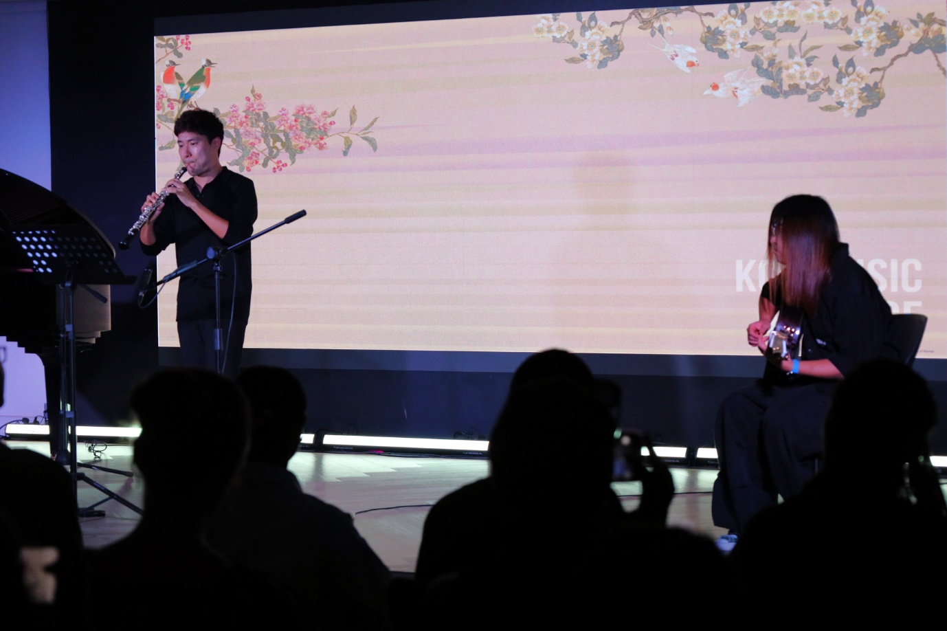 A group of people playing instruments

AI-generated content may be incorrect.